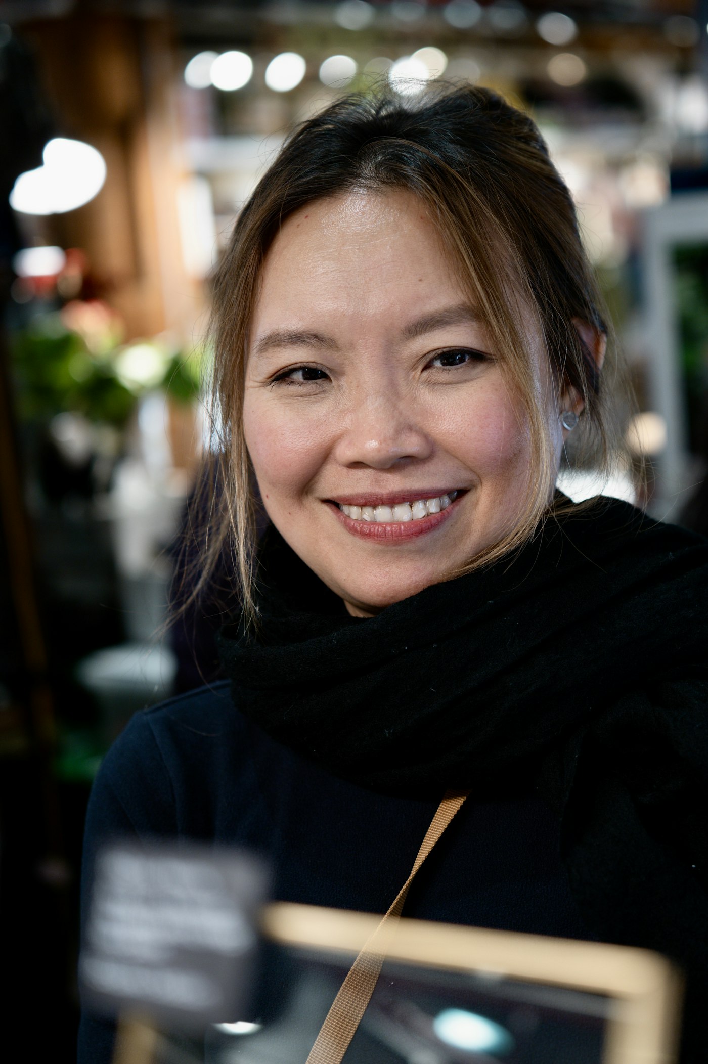 Lena Cho, smiling, in a dark scarf