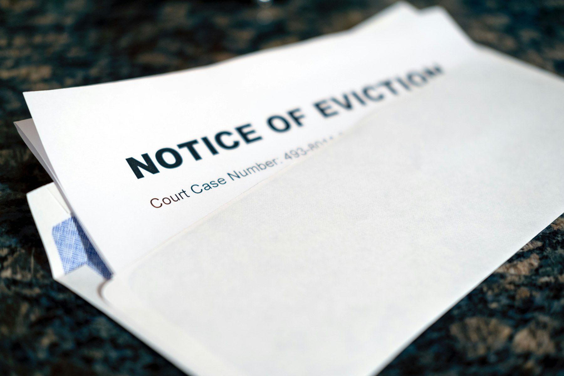 An eviction notice with a court case number on its envelope