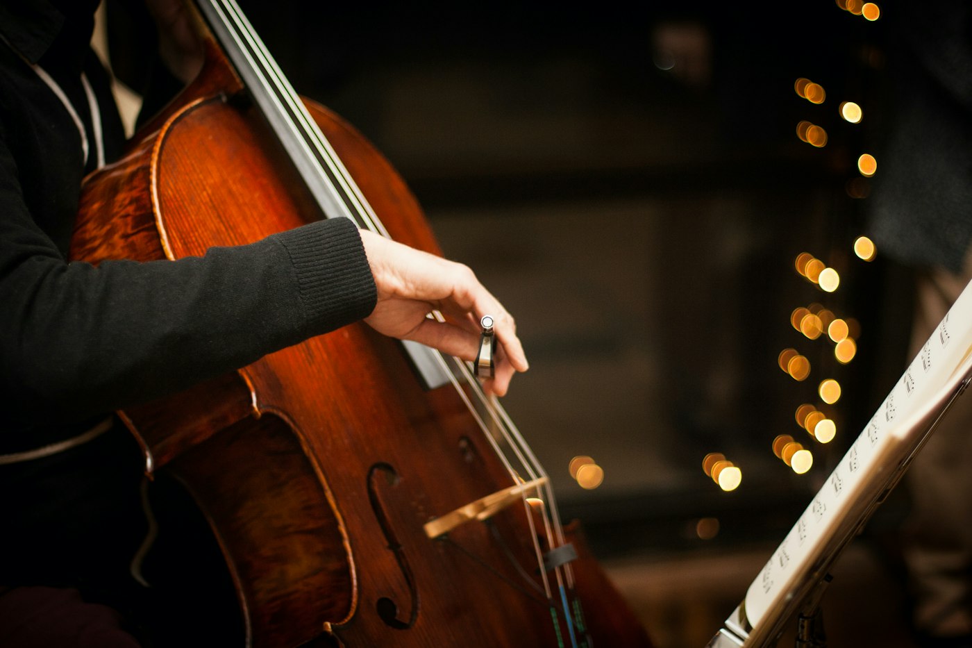 An adult student playing the cello