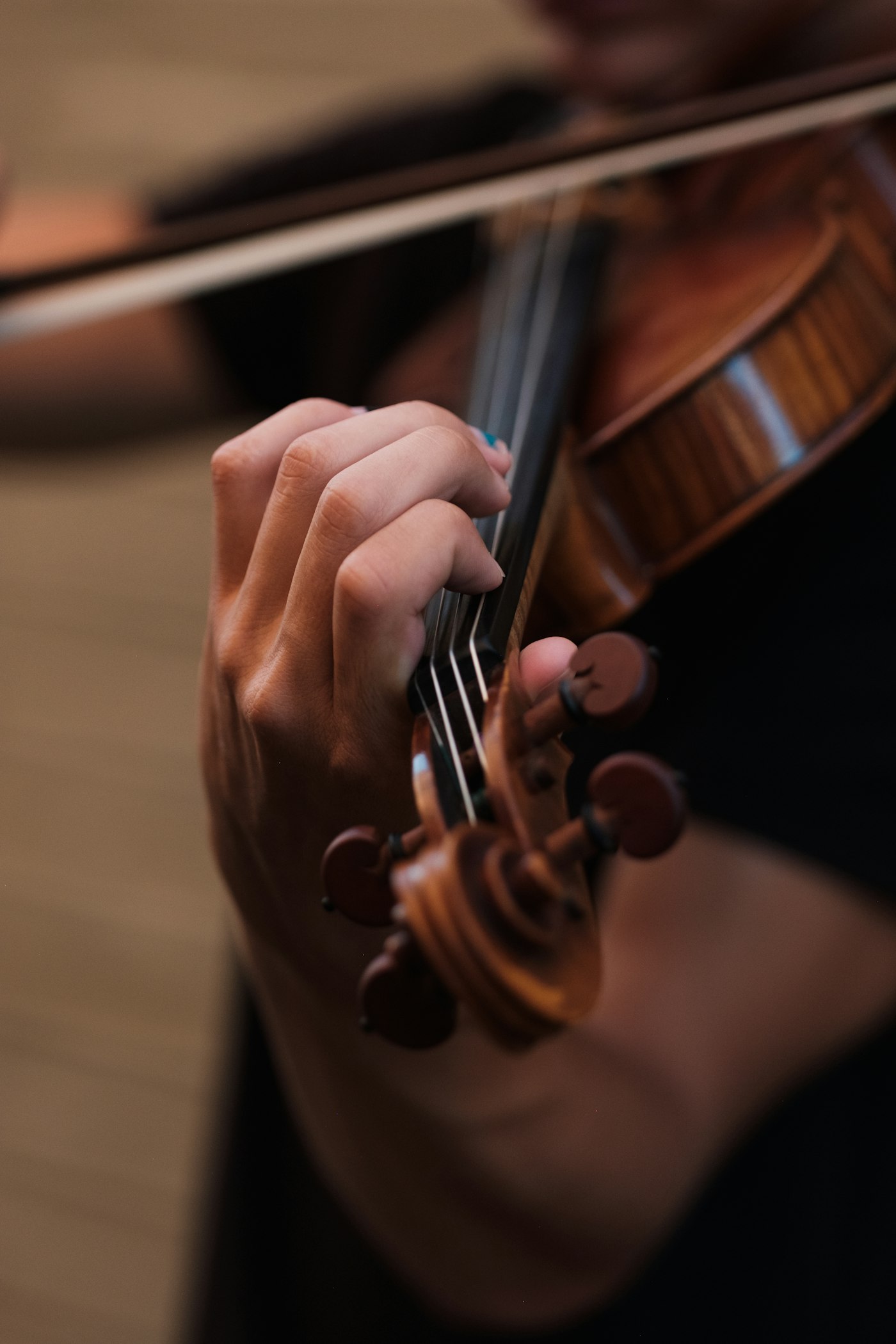 Close-up of a violinist's hand on the strings