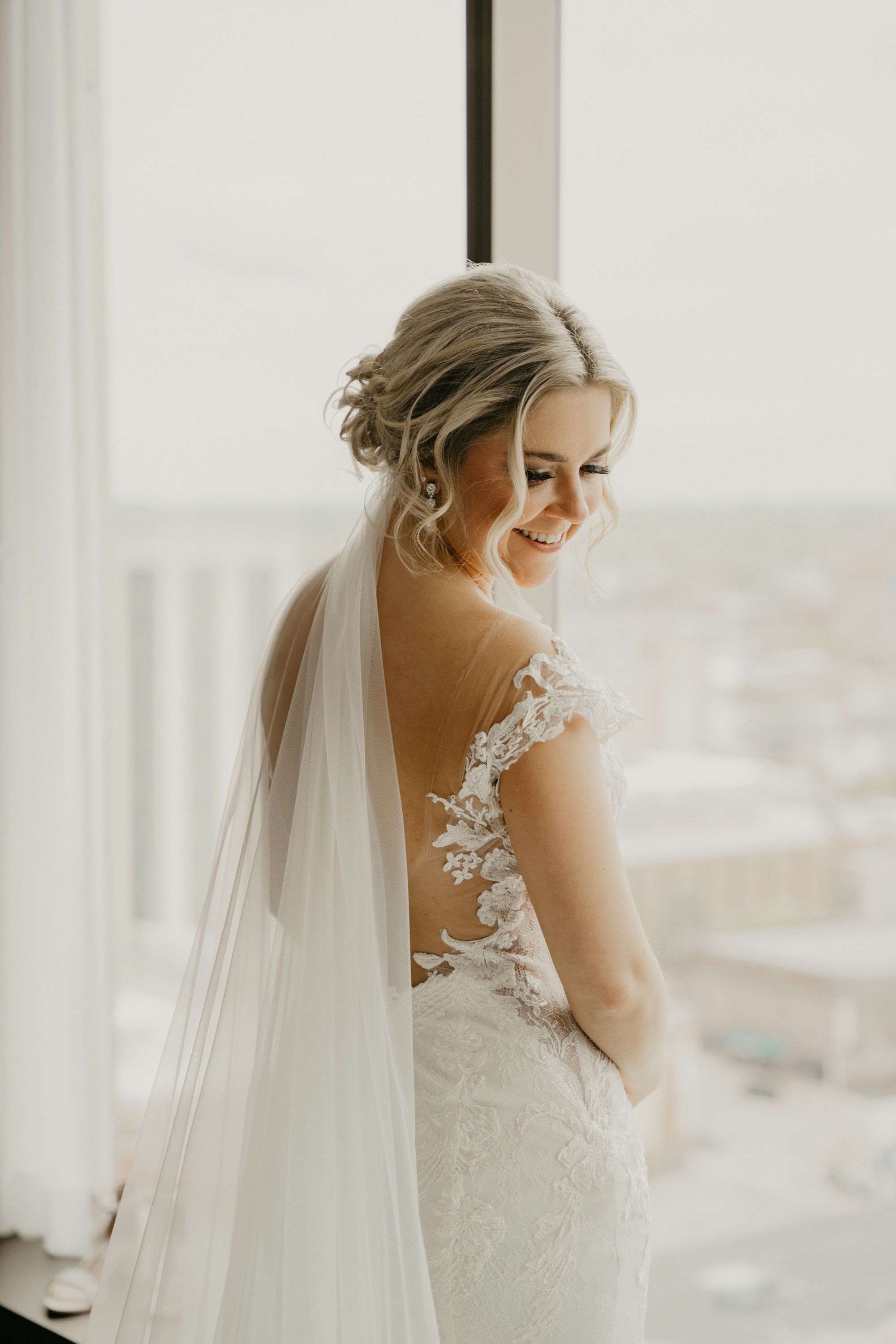 Hannah smiling, her hair in a soft updo
