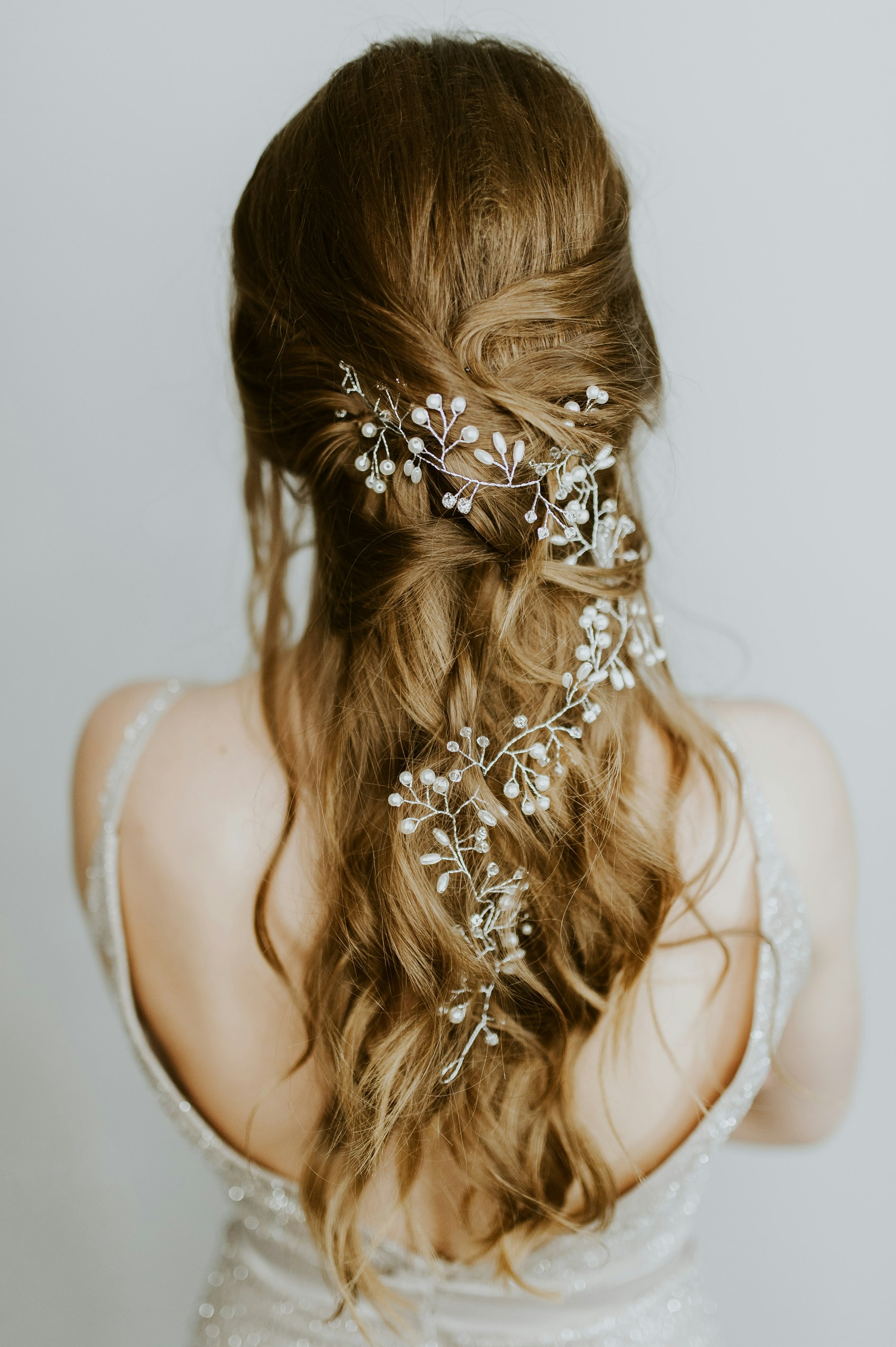 A braided updo threaded with a gold hair vine