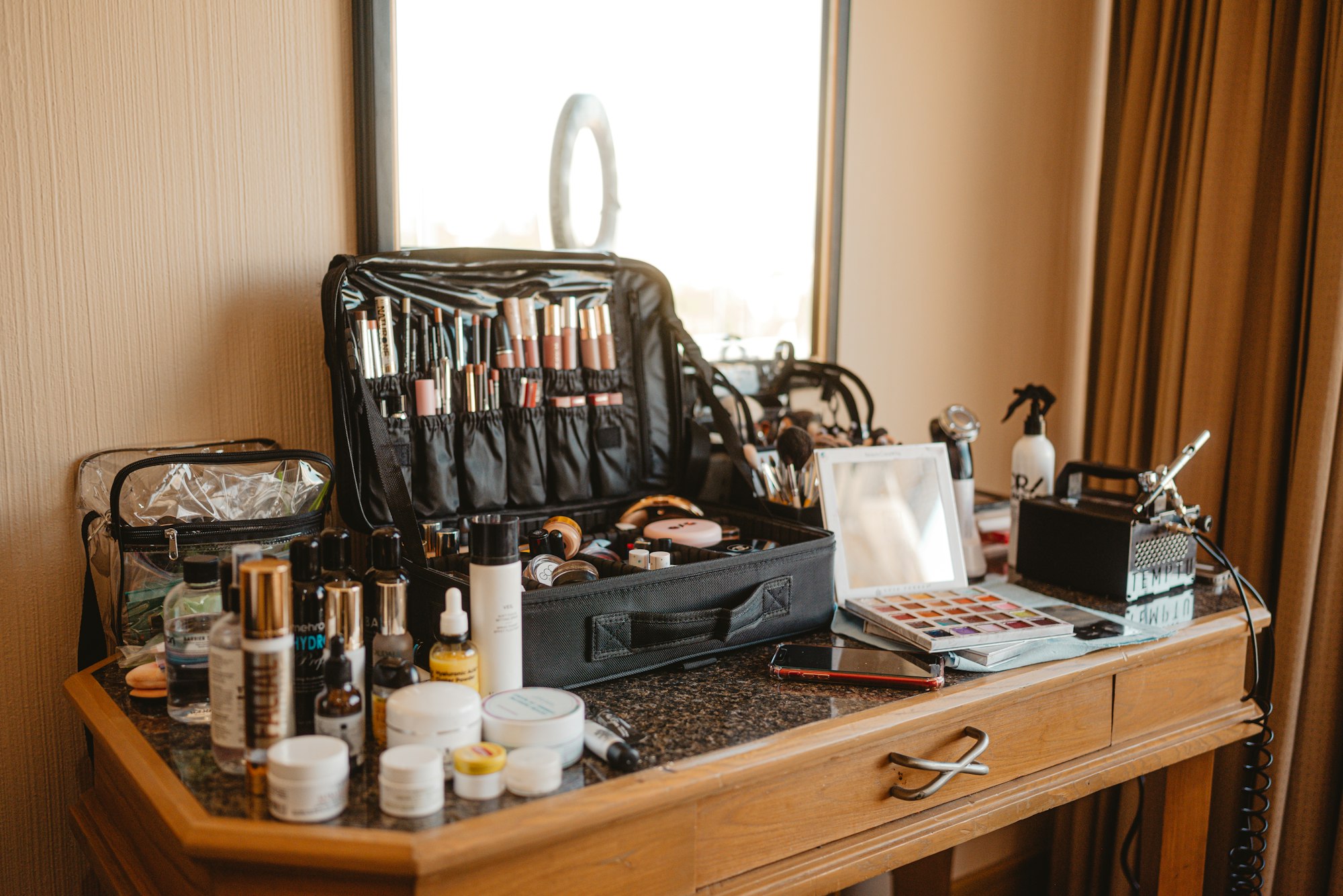 Brushes and palettes laid out at the studio vanity under a ring light