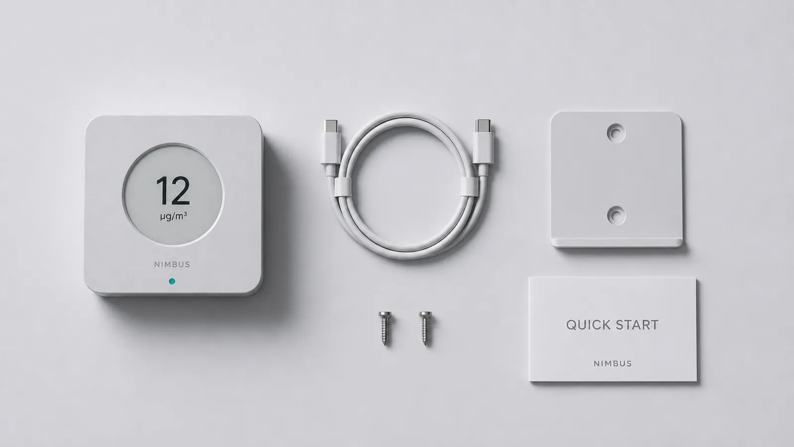 Top-down flatlay of the box contents: the monitor, a coiled USB-C cable, the wall bracket with two screws, and a folded quick-start card.
