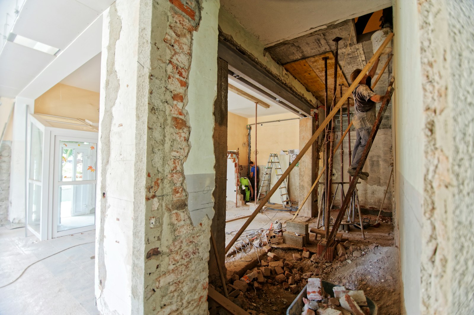 Mid-build: a bearing wall opened, with temporary posts holding the floor above