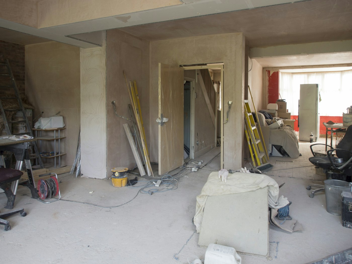 Mid-build: the Como kitchen and dining room plastered, tools on the floor
