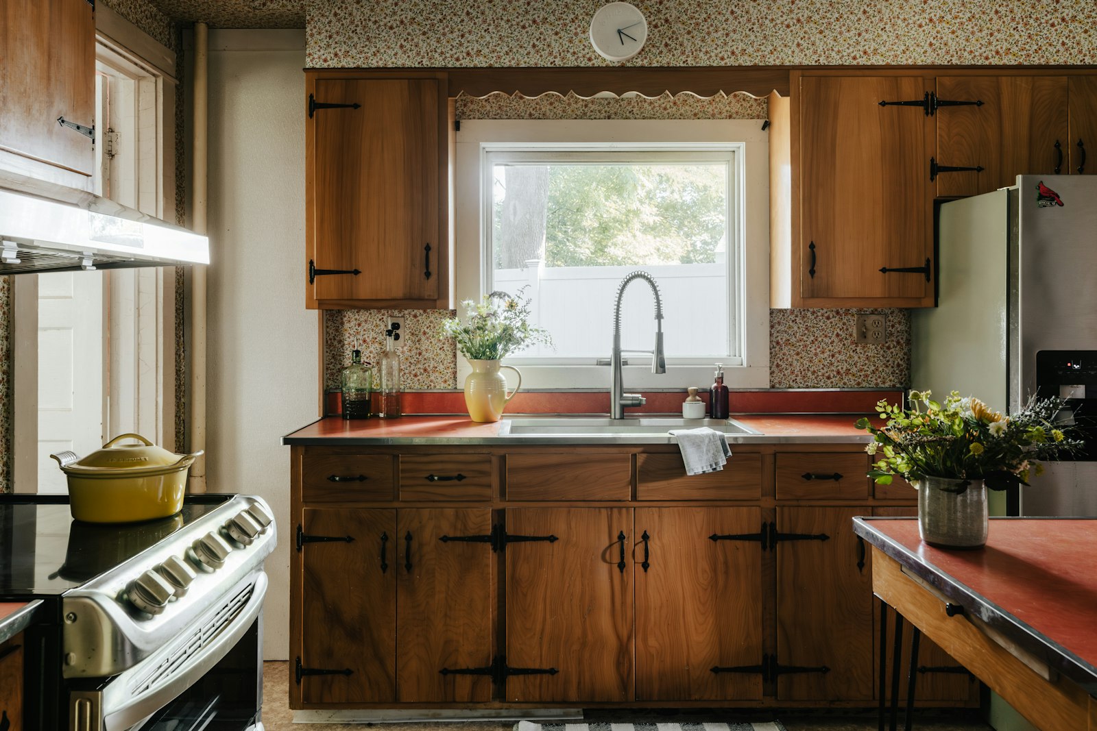 The Como kitchen: walnut cabinets and a red counter
