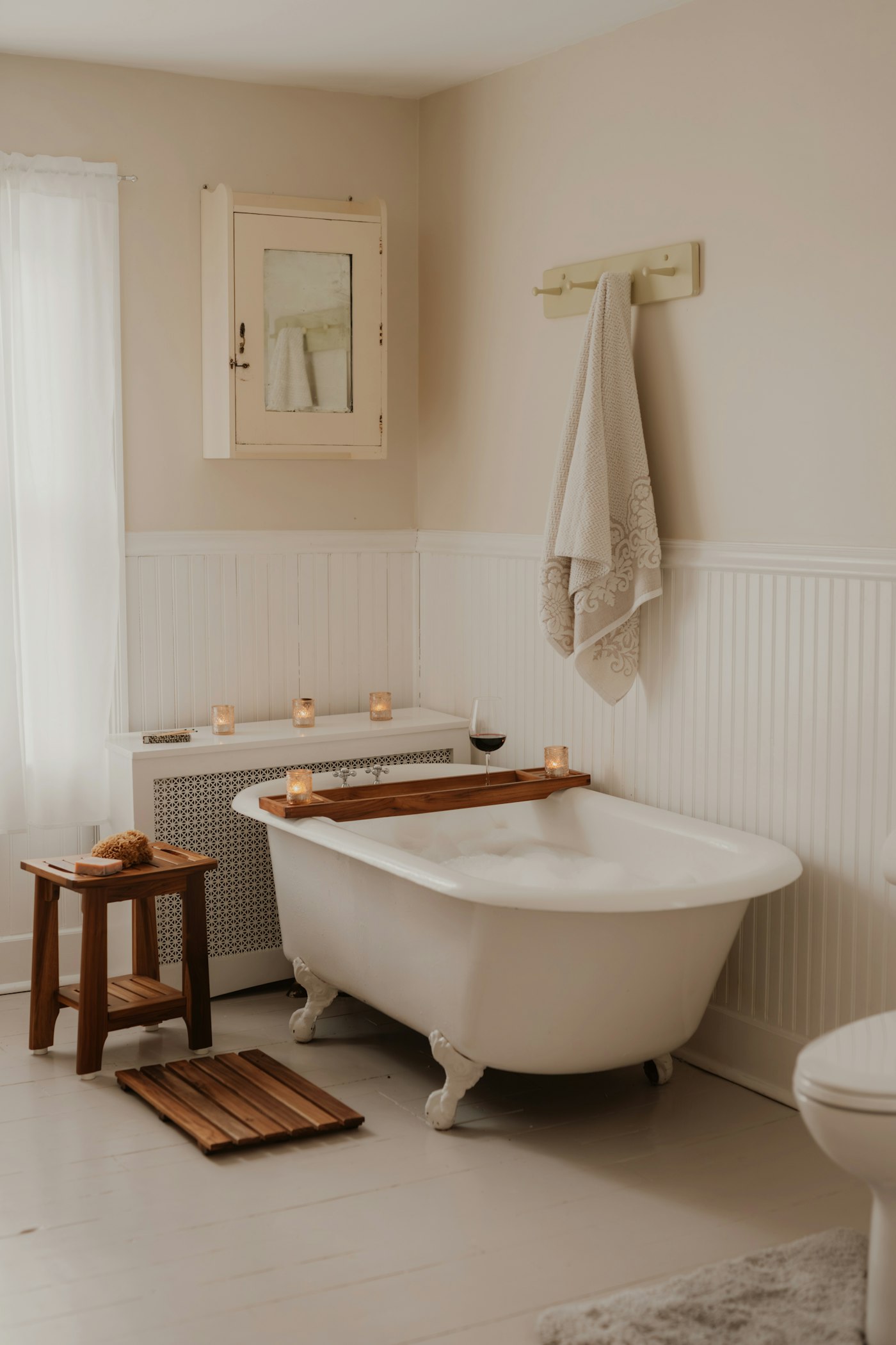 The Longfellow bathroom: clawfoot tub and white beadboard