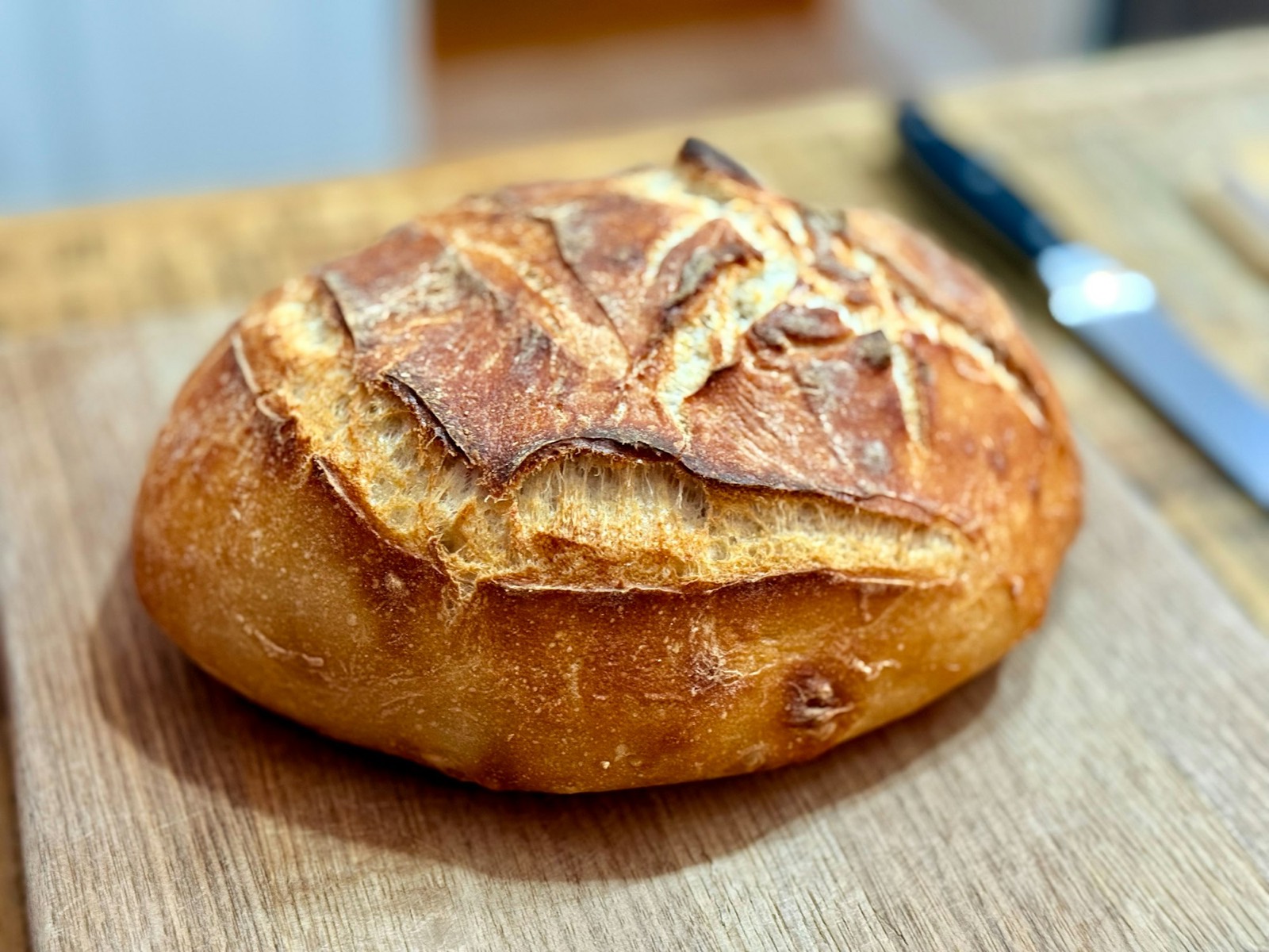 A round country loaf on a wooden board