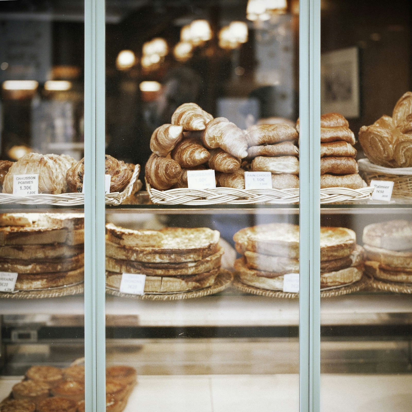 Pastries and loaves behind a café window
