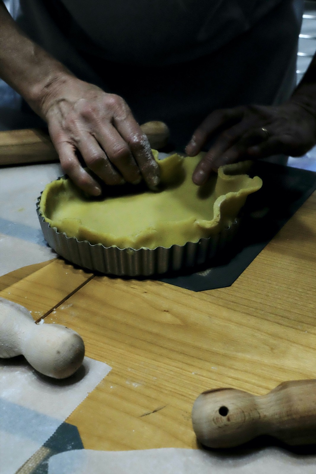 Leila pressing pastry into a fluted tart tin