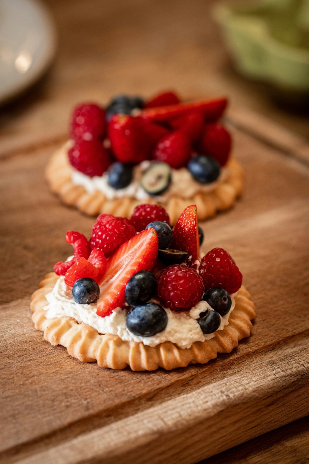 Small fruit tarts with berries on a wooden board